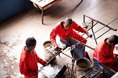 Buy stock photo Glassblowers, artisan and men manufacturing vase for equipment, professional craft and production. Industrial, factory or top view of molding object with tools for manual labor, teamwork or heating