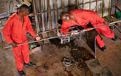 Buy stock photo Glassblowers, heating and people in factory with production and equipment for professional craft. Labor, workshop and shaping object with tools for metalwork, manufacturing and forge for teamwork