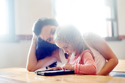 Buy stock photo Mother, daughter and learning with tablet in home for online education, watching cartoon or child development. Woman, girl or tech for streaming subscription, reading support or gaming app with flare