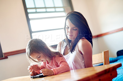 Buy stock photo Mother, girl and relax with tablet in home for online movie, watching educational cartoon and bonding. Woman, child and digital tech for streaming subscription, playing games and learning app search