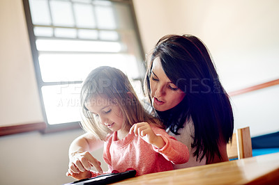Buy stock photo Home, tablet and mother with girl, internet and bonding together with social media. Parent, family and mama with daughter, technology and help with break, online activity and digital app for videos