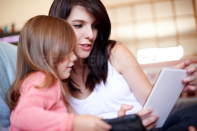 Buy stock photo Tablet, relax and mom with child on sofa in living room for interactive learning app for development. Education, bonding and mother with girl kid on digital technology for online brain games in home.