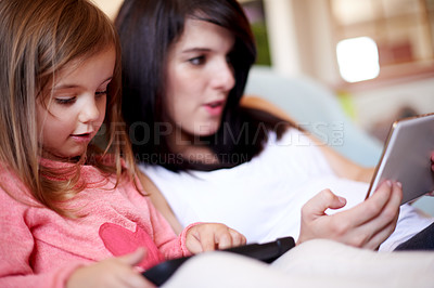 Buy stock photo Tablet, relax and mom with kid on sofa in living room for interactive learning app for development. Education, bonding and mother with girl child on digital technology for online brain games in home.