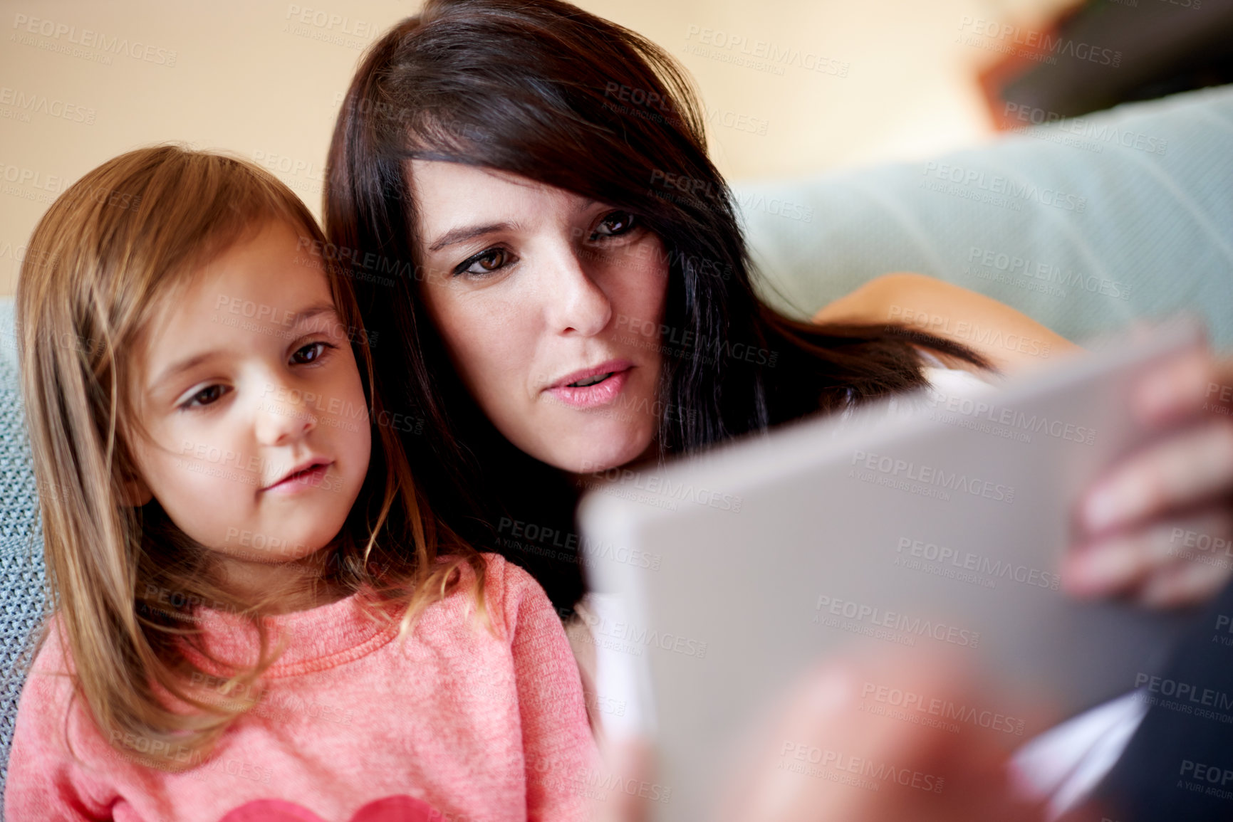 Buy stock photo Tablet, relax and mother with child in living room on sofa for interactive learning app for development. Education, bonding and mom with girl kid on digital technology for online brain games in home.
