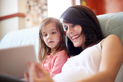 Buy stock photo Tablet, elearning and mom with child on sofa in living room for interactive learning app for development. Education, bonding and mother with girl kid on technology for online brain games in home