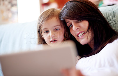 Buy stock photo Tablet, elearning and mother with kid on sofa in living room for interactive learning app for development. Education, bonding and mom with girl child on technology for online brain games in home.