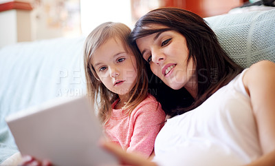 Buy stock photo Tablet, education and mother with child on sofa in living room for interactive learning app for development. Family, bonding and mom with girl kid on digital technology for online brain games in home