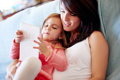 Buy stock photo Bonding, mom and child with tablet, online and watching cartoons for entertainment, family and home. Digital, woman and tech for movies with daughter, streaming or smile for videos in apartment