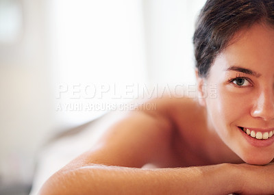 Buy stock photo Massage, smile and portrait of woman at spa with hospitality, peace and zen with luxury hotel service. Relax, happy space and calm girl on table at wellness clinic for holistic self care treatment.