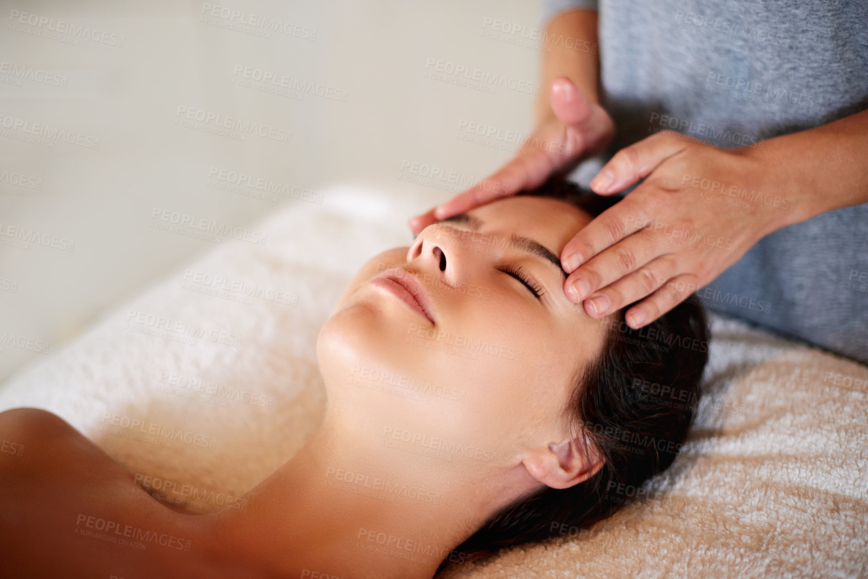 Buy stock photo Face, massage and girl on bed at spa for skincare, peace and acupressure with luxury hotel service. Relax, self care and woman on table at beauty salon for holistic facial, wellness or skin treatment
