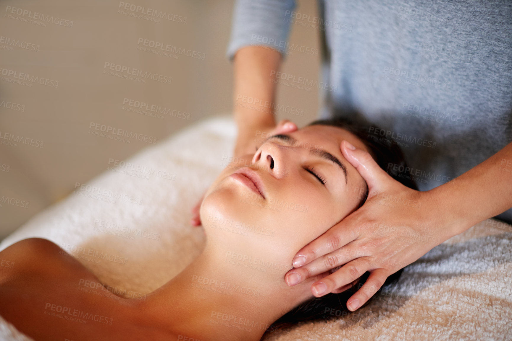 Buy stock photo Face, massage and girl on table at spa for skincare, peace and acupressure with luxury hotel service. Relax, self care and woman on bed at beauty salon for holistic facial, wellness or skin treatment