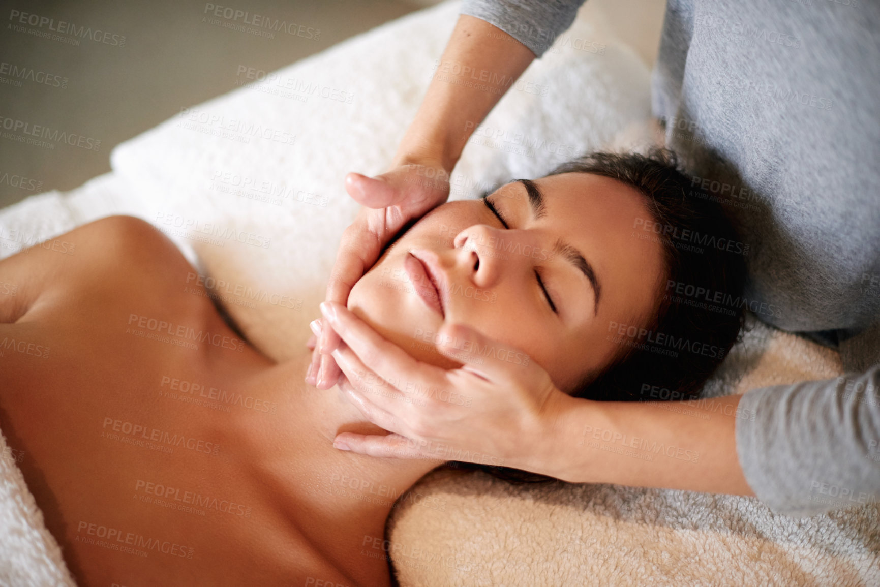 Buy stock photo Face, massage and woman on bed at salon for skincare, peace and acupressure with luxury hotel service. Relax, self care and girl on table at beauty spa for holistic facial, wellness or skin treatment