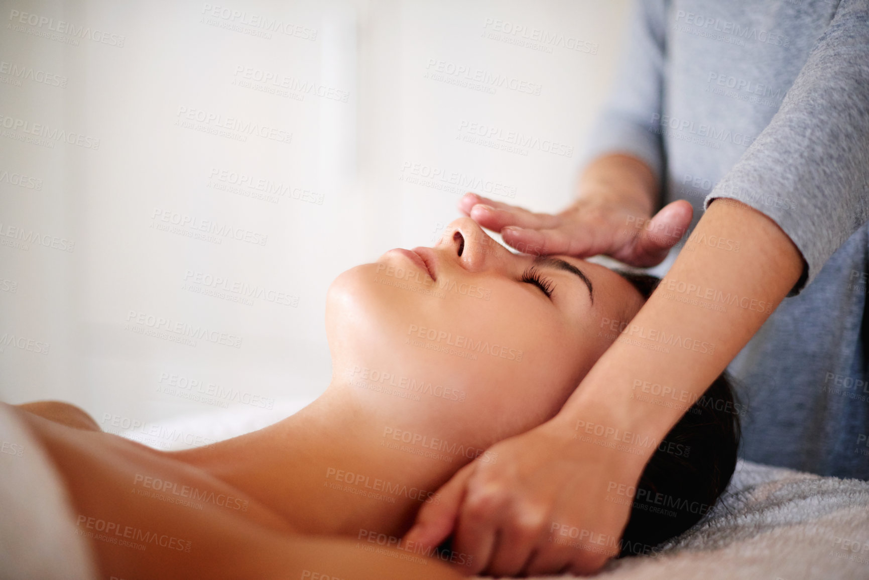 Buy stock photo Face, massage and woman on table at spa for skincare, peace and acupressure with luxury hotel service. Relax, self care and girl on bed at beauty salon for holistic facial, wellness or skin treatment