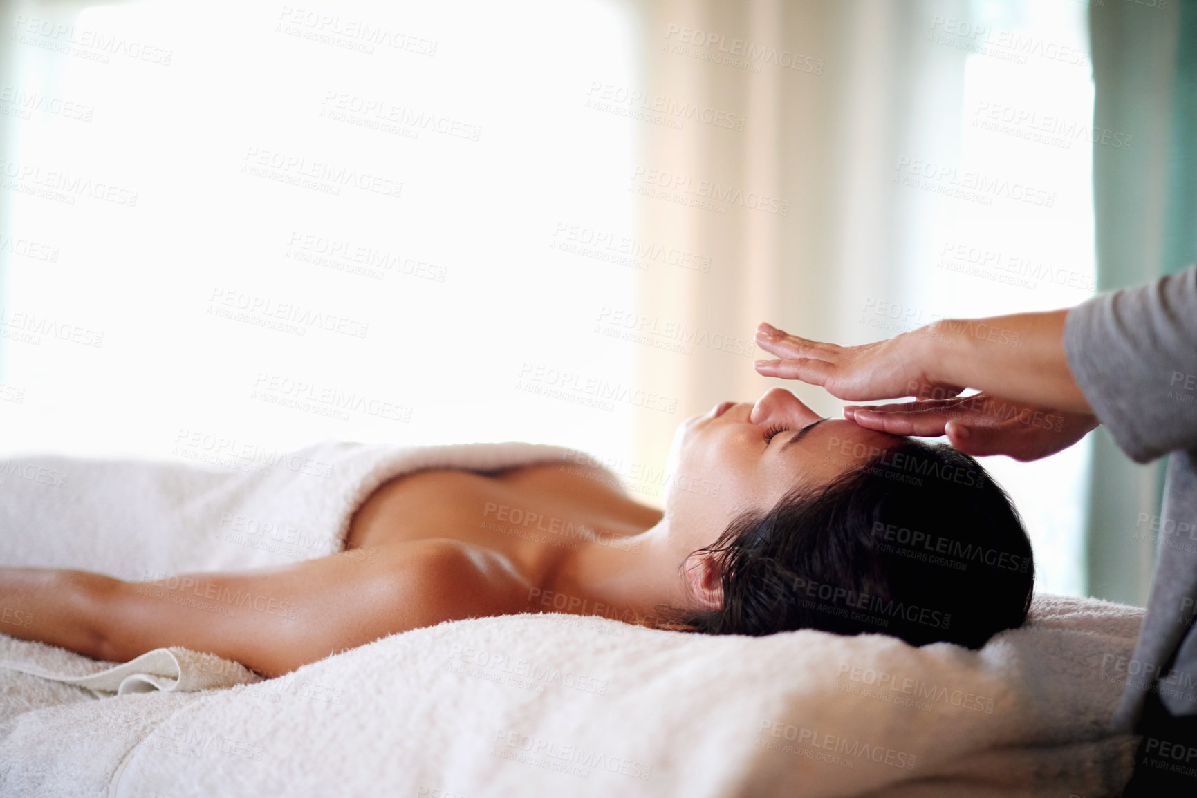 Buy stock photo Face, massage and woman on bed at spa for skincare, peace and acupressure with luxury hotel service. Relax, self care and girl on table at beauty salon for holistic facial, wellness or skin treatment