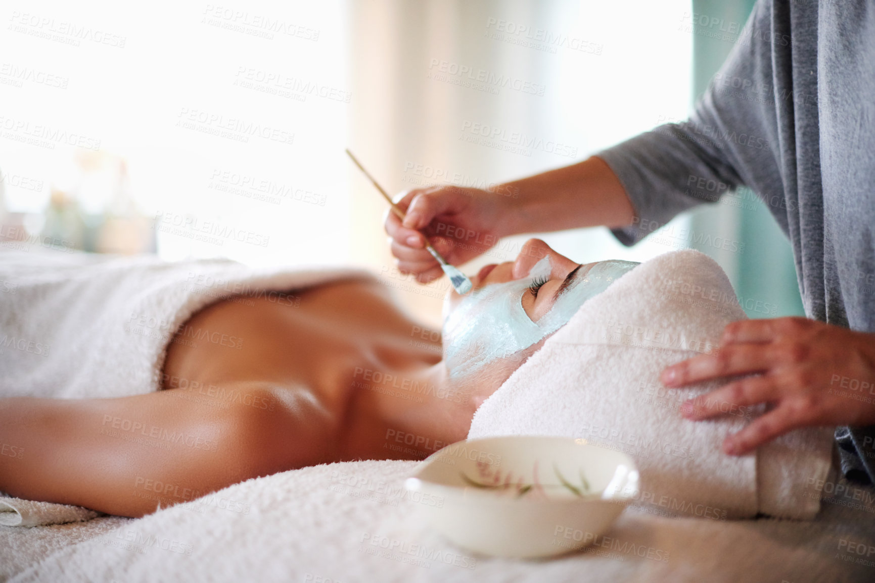 Buy stock photo Skincare, beautician and woman with facial at spa for skin hydration, moisturizer or acne treatment. Hands, client and clay mask at beauty salon for face cleansing, stress relief and self care pamper