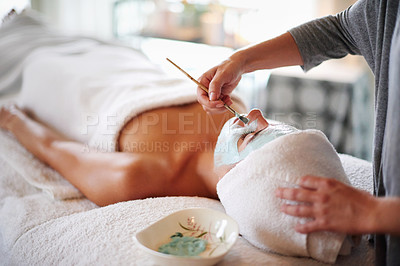 Buy stock photo Beauty, hands and client with facial at spa for skin exfoliation, hydration and acne treatment. Beautician, woman and clay mask at health clinic for face cleansing, self care retreat and cosmetology