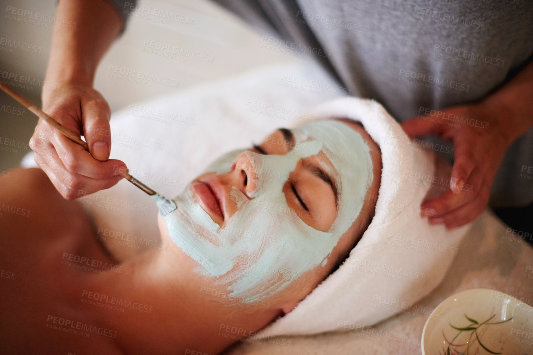 Buy stock photo Skincare, above and hands of woman with facial at spa for exfoliation, skin wellness and acne treatment. Beautician, client and mask at beauty salon for face cleansing, anti aging or self care pamper