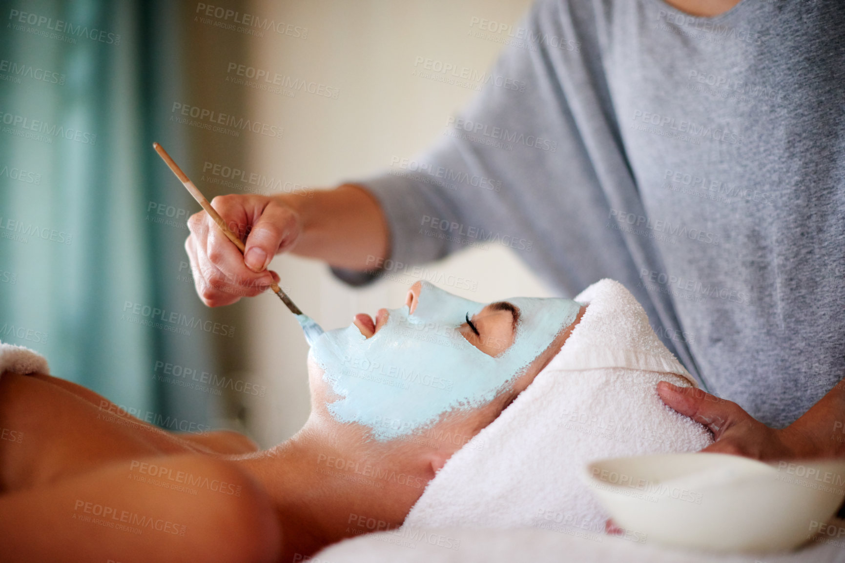 Buy stock photo Skincare, hands and woman with facial at beauty salon for skin exfoliation, relaxation and acne treatment. Beautician, client and clay mask at spa for face cleansing, stress relief and dermatology