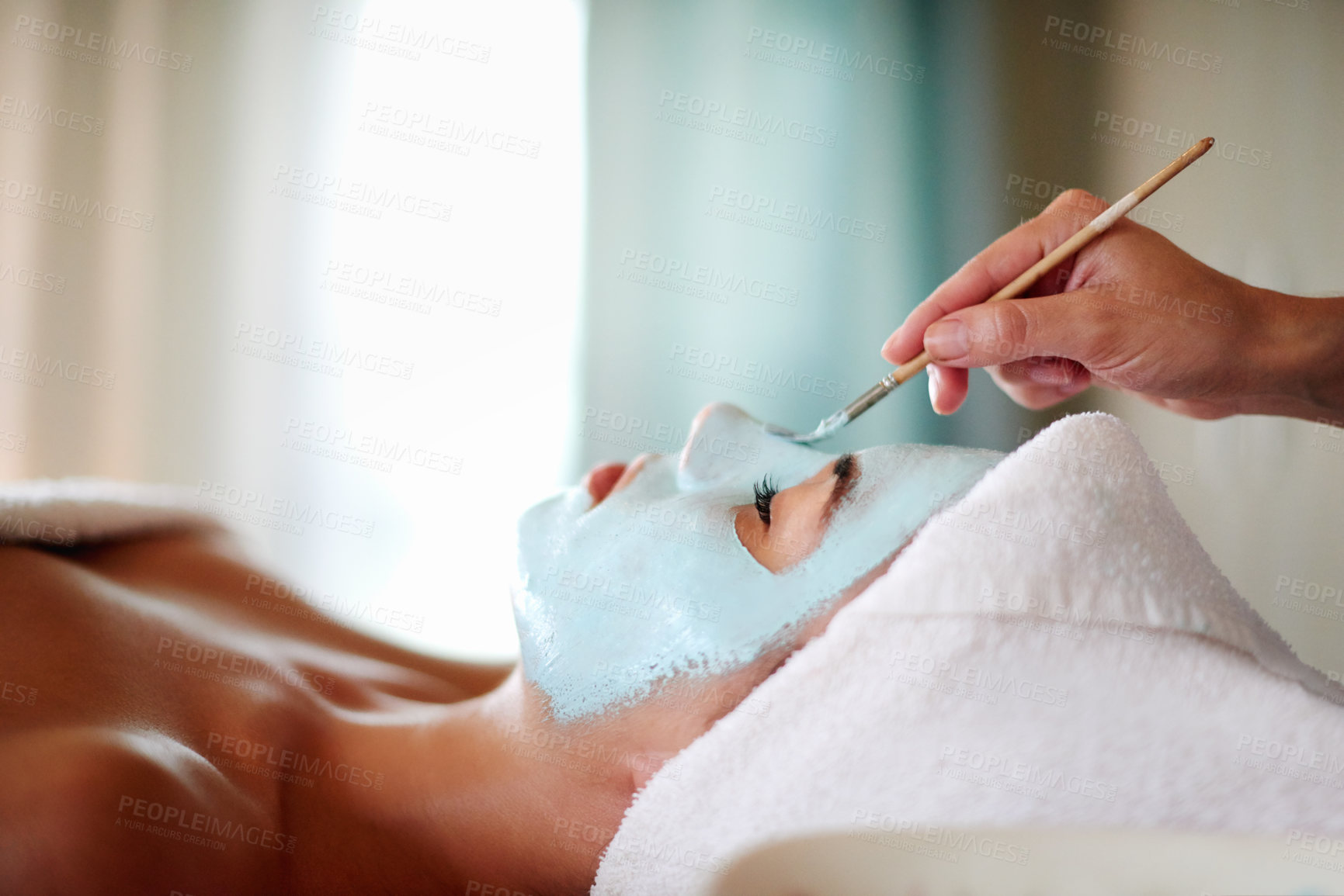 Buy stock photo Beauty, hands and client with mask application for facial treatment, skin hydration and self care retreat. Pamper, beautician and woman with clay for moisturiser or natural glow at skincare salon