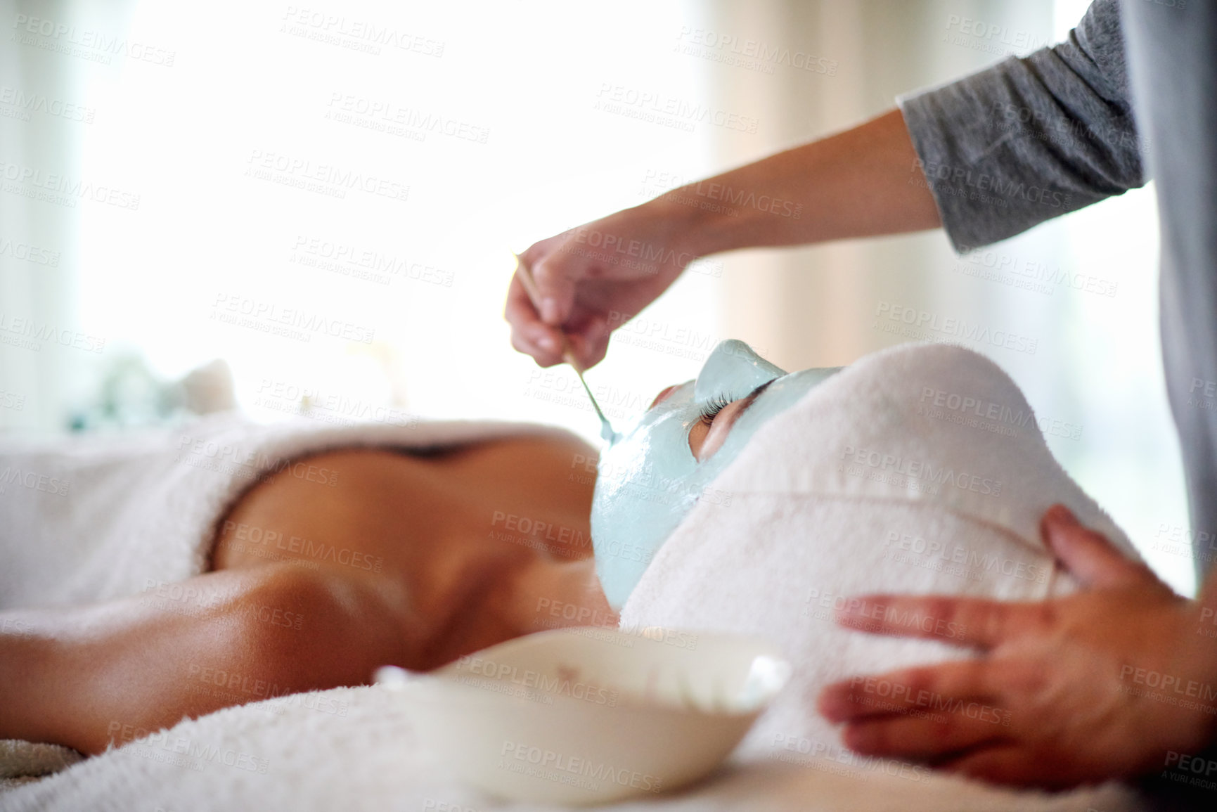Buy stock photo Skincare, hands and woman with facial at spa for skin exfoliation, hydration and acne treatment. Beautician, client and clay mask at beauty salon for face cleansing, anti aging and self care pamper