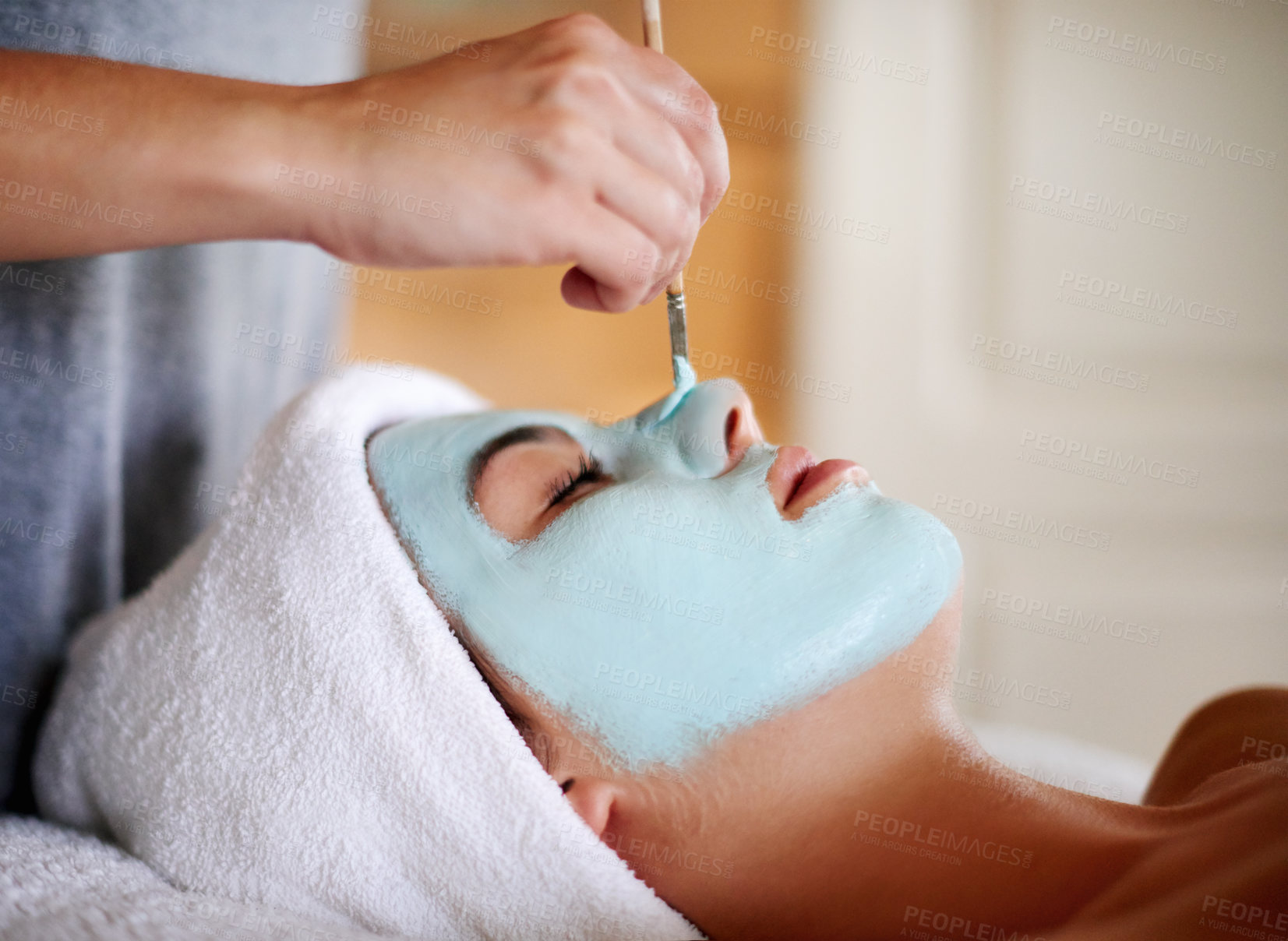 Buy stock photo Beauty, beautician and client with mask application for facial treatment, skin hydration and face rejuvenation. Spa pamper, hands or woman with clay for relaxation and natural glow at skincare salon