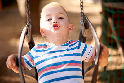 Buy stock photo Fun, swing and portrait of kid in park with play, outdoor adventure and child development in nature. Relax, wellness and happy boy in playground for growth, morning games or playful childhood weekend