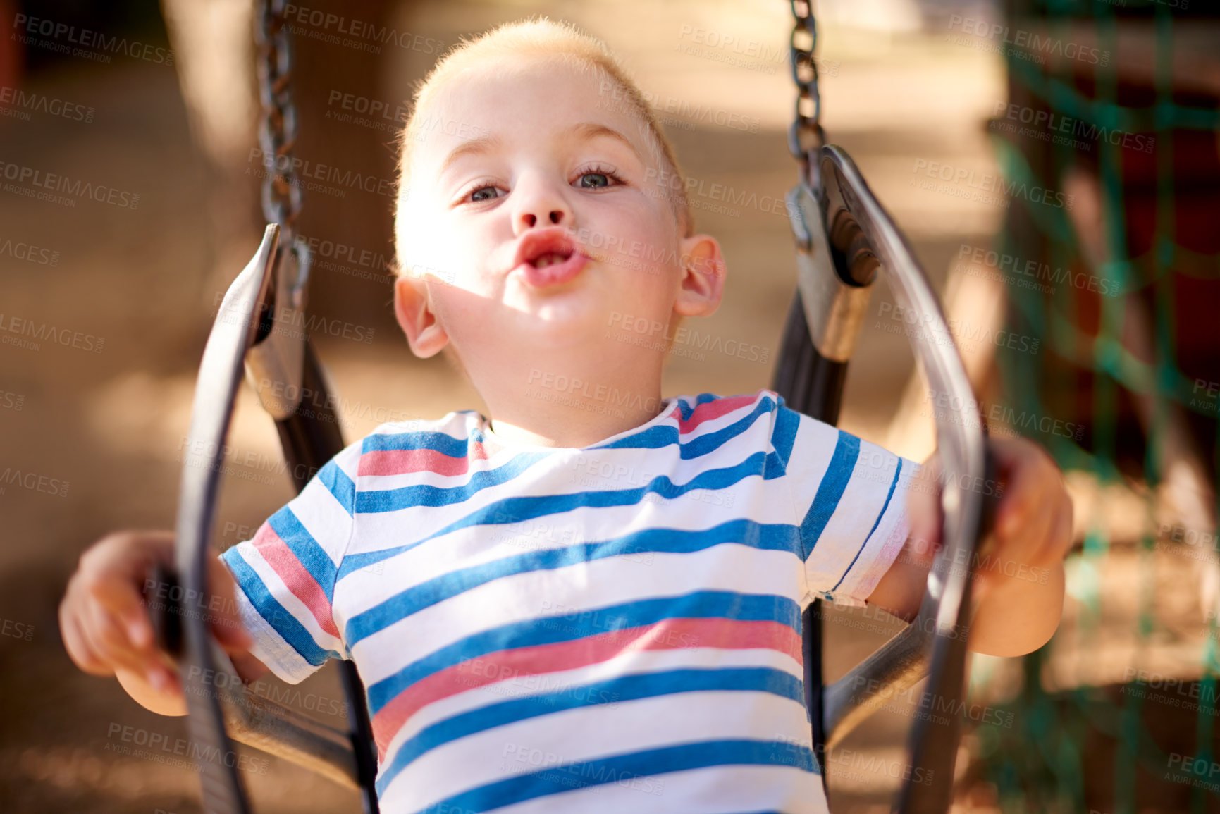 Buy stock photo Fun, swing and portrait of kid in park with play, outdoor adventure and child development in nature. Relax, wellness and happy boy in playground for growth, morning games or playful childhood weekend