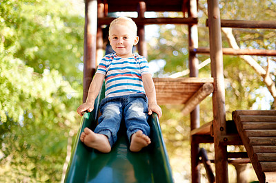 Buy stock photo Happy, playing and portrait of child on slide in park for physical skills, confidence or fun. Exploring, nature and boy kid on playground equipment for adventure, hobby or cognitive development.