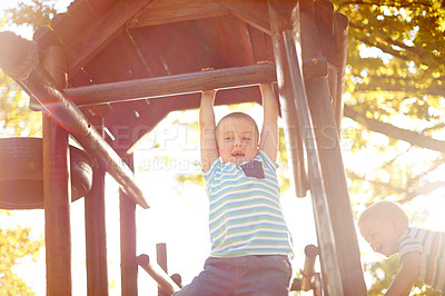 Buy stock photo Playing, jungle gym and kid in park with exploring, adventure or fun hobby in nature. Happy, activity and boy child swing on wooden playground equipment for cognitive development outdoor in field.