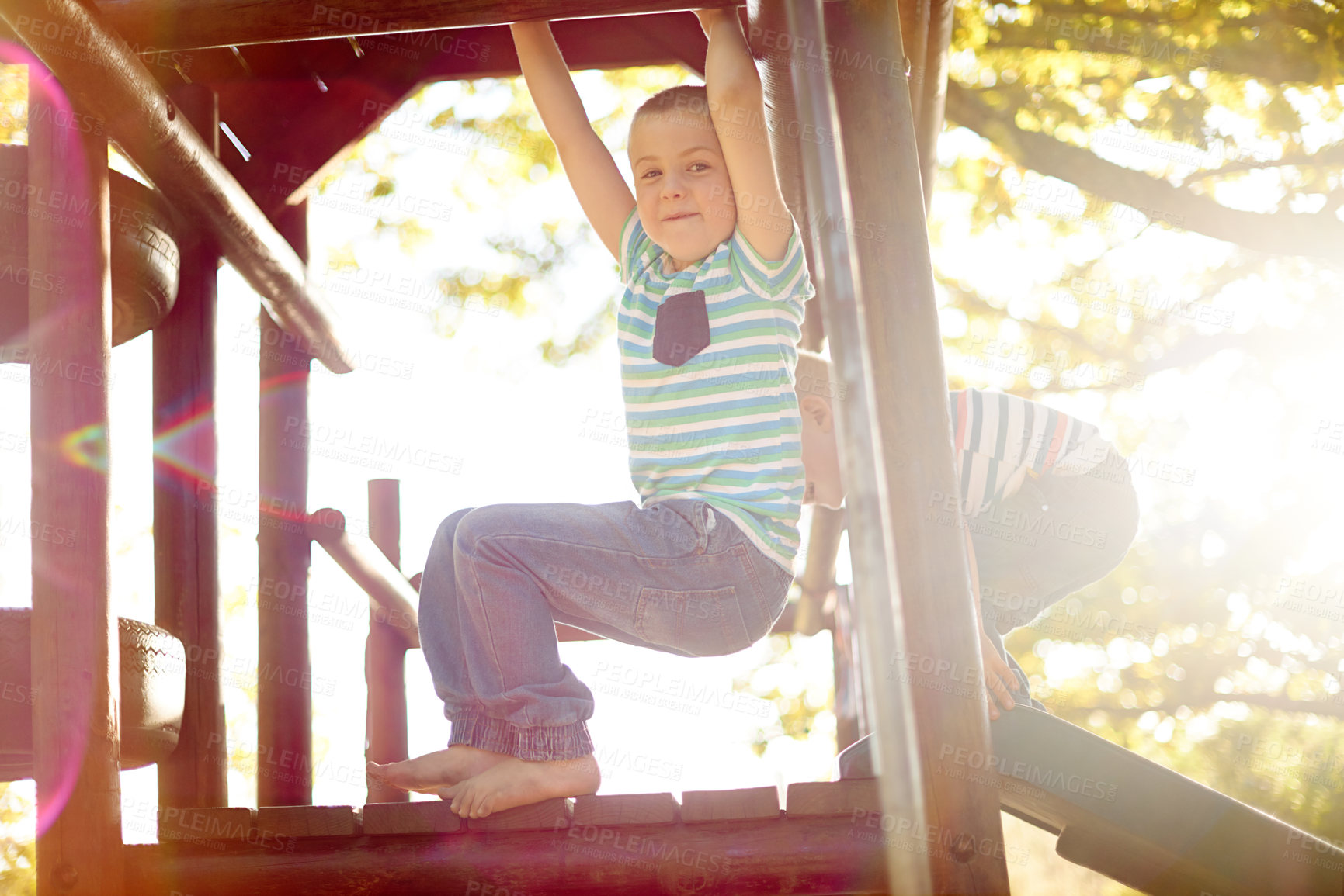 Buy stock photo Playing, jungle gym and portrait of child in park with exploring, adventure or hobby in nature. Happy, activity and boy climb on wooden playground equipment for cognitive development outdoor in field