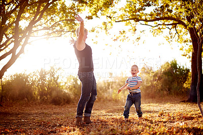 Buy stock photo Autumn, leaves and mom with child in nature for playing games, bonding and have fun together. Family, park and mother with kid excited for season change for childhood, adventure and freedom outdoors