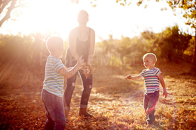 Buy stock photo Happy, leaves and mom with children in nature for playing games, bonding and have fun together. Family, park and mother with kid excited for season change, autumn or fall for childhood outdoors