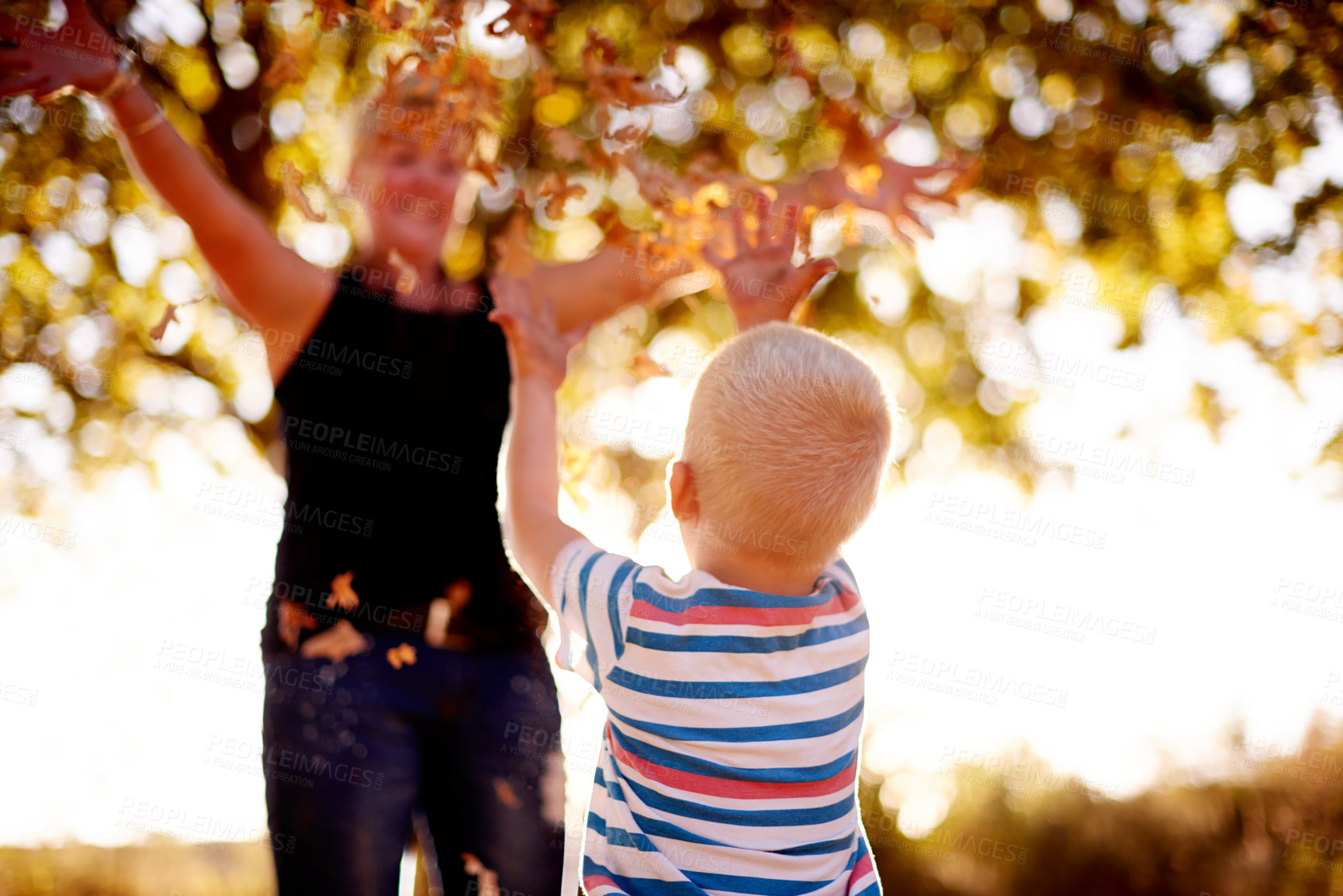 Buy stock photo Throwing, leaves and mom with child in nature for playing games, bonding and have fun together. Family, park and mother with kid excited for season change, autumn and fall for childhood outdoors