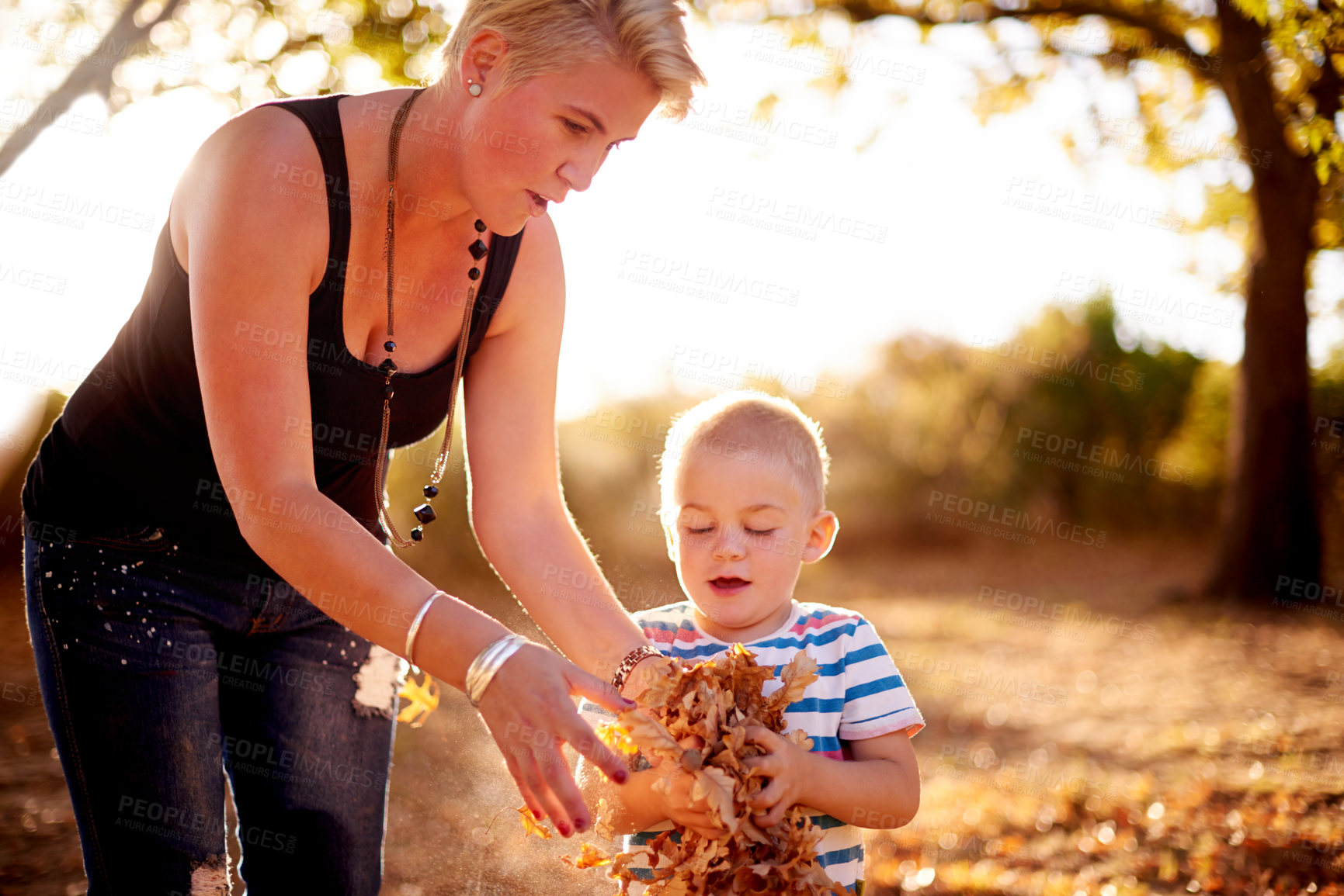 Buy stock photo Family, leaves and mom with child in nature for playing games, bonding and have fun together. Happy, park and mother with kid excited for season change, autumn and fall for childhood outdoors