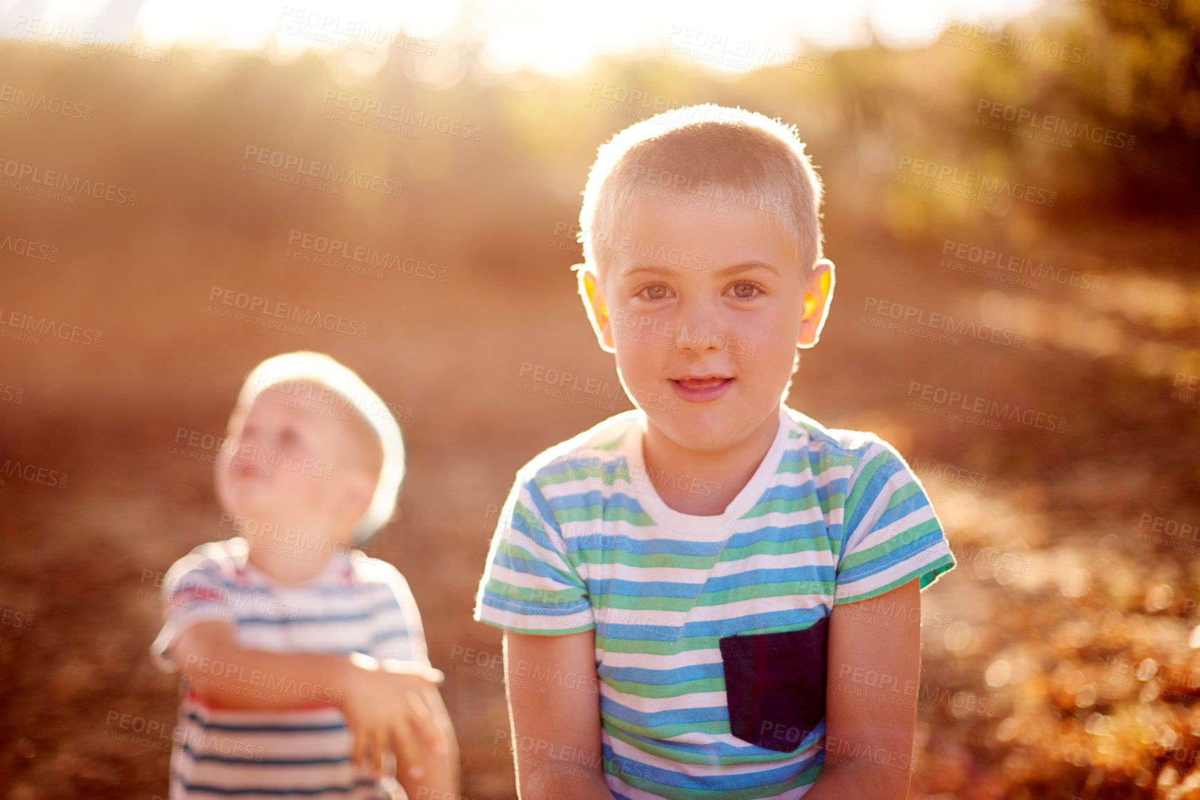 Buy stock photo Portrait, nature and brothers in park, game and smile with energy, bonding together and happiness. Face, boys and siblings with joy, lens flare and countryside with childhood development and break