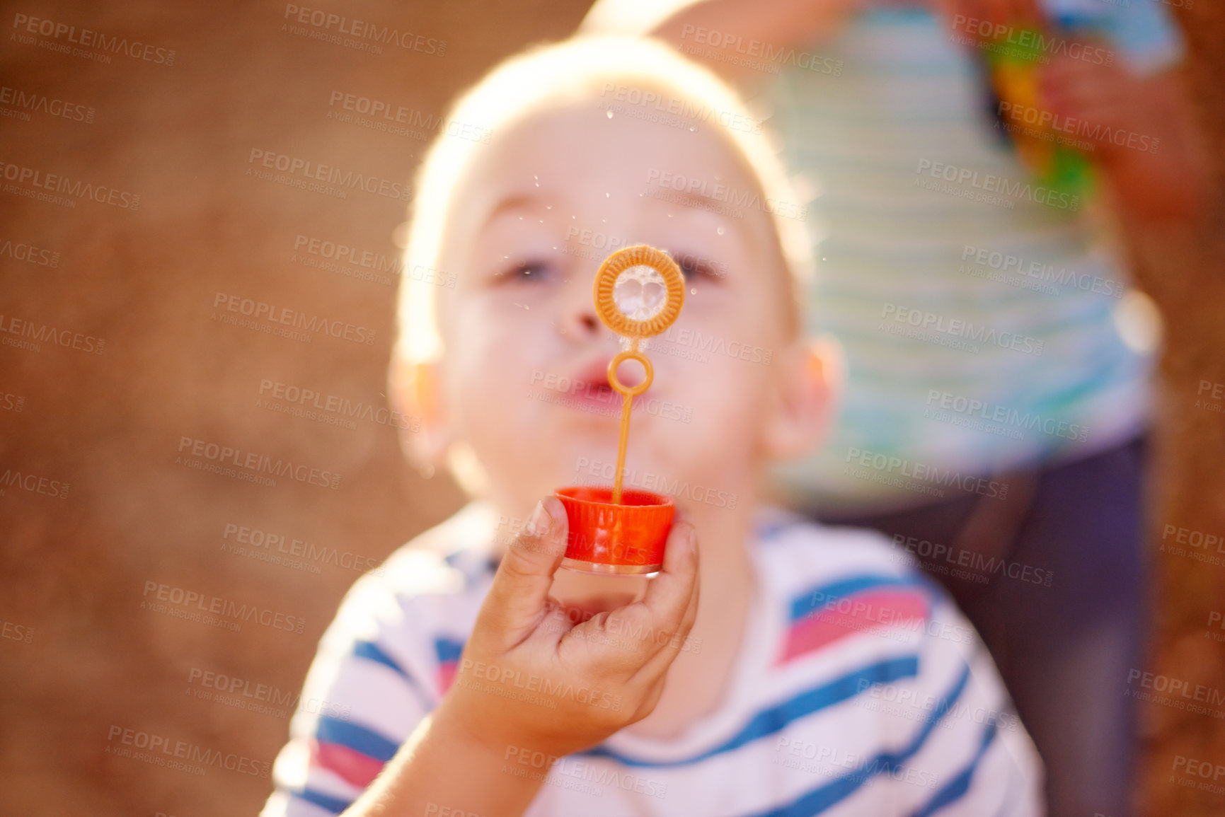 Buy stock photo Bubbles, blowing and boy in park with play, sunset adventure and outdoor development for kids in nature. Relax, weekend and child in garden playground with soap wand, childhood games and fun activity