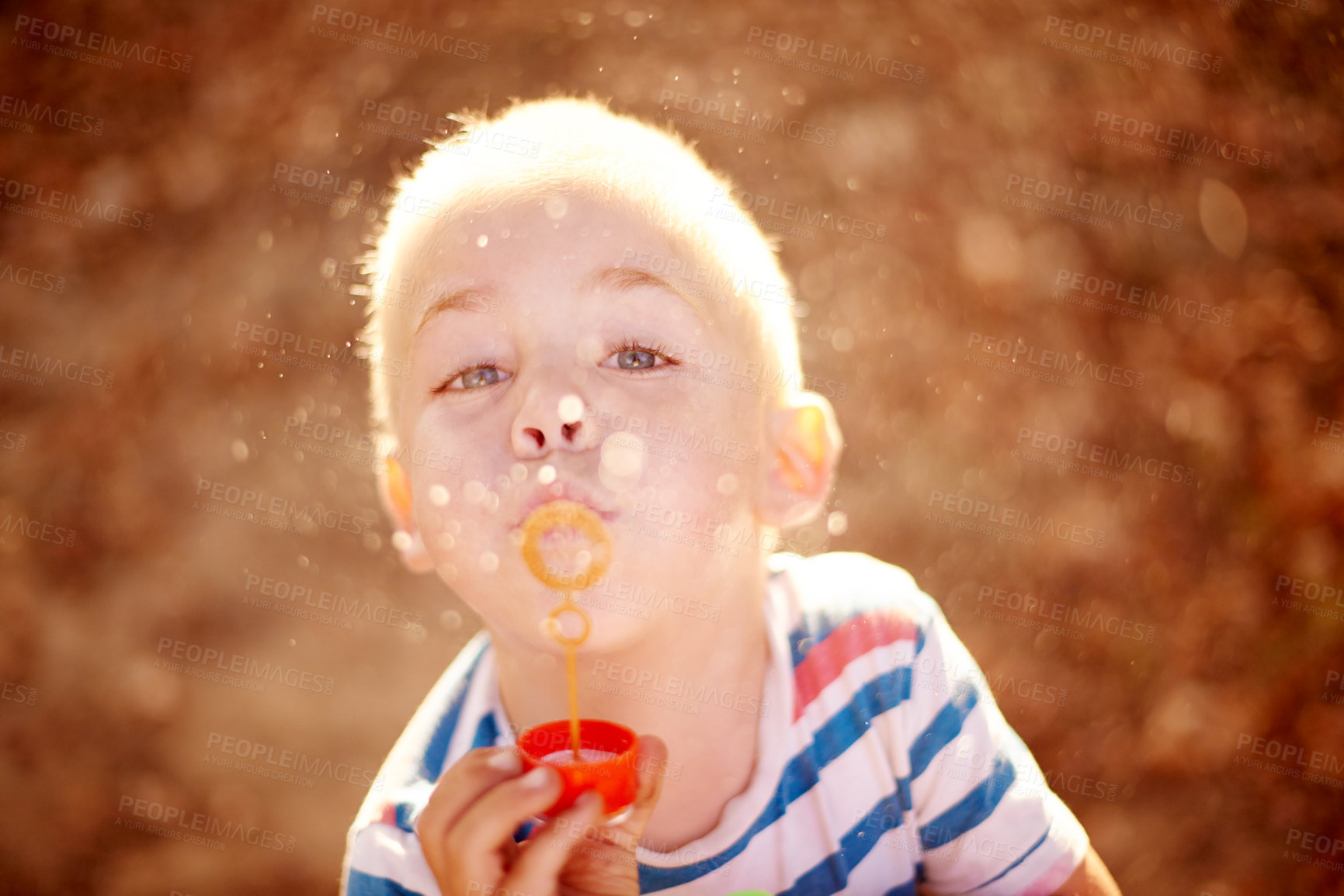 Buy stock photo Bubbles, portrait and child in park with fun, sunset adventure and outdoor development for kids in nature. Relax, weekend and boy in garden playground with soap wand, childhood games or play activity