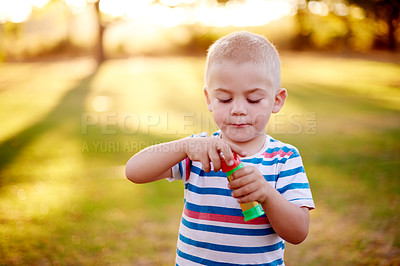 Buy stock photo Bubbles, play and child in park with fun, sunset adventure and outdoor development for kids in nature. Relax, weekend and boy in garden playground with soap wand, childhood games and playful activity