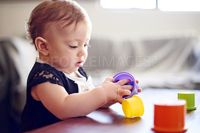 Buy stock photo Home, baby and child with toys for development, playing and motor skills for stack. House, girl and childhood with plastic cups for sensory interaction, learning or cognitive growth with curious game