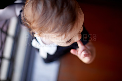 Buy stock photo Top view, baby girl and child in home for relax, thinking or imagine or dream in nursery. Cute kid, youth or adorable toddler with growth, healthy development or finger in mouth for teething in house