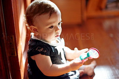 Buy stock photo Home, baby and child development with toys for playing, entertainment and motor skills on floor. House, girl or kid with plastic rattle for sensory interaction, learning and curious for imagination