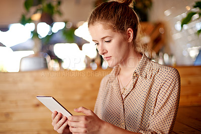 Buy stock photo Coffee shop, typing and business woman on tablet in cafe for social networking, internet and research. Remote work, restaurant and person on digital tech for website, connection and contact on break