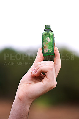 Buy stock photo Person, hand and bottle in nature for recycle, social responsibility and environment care. Man, volunteer and outdoor with glass vial to collect rubbish, cleaning and Earth Day awareness with ecology