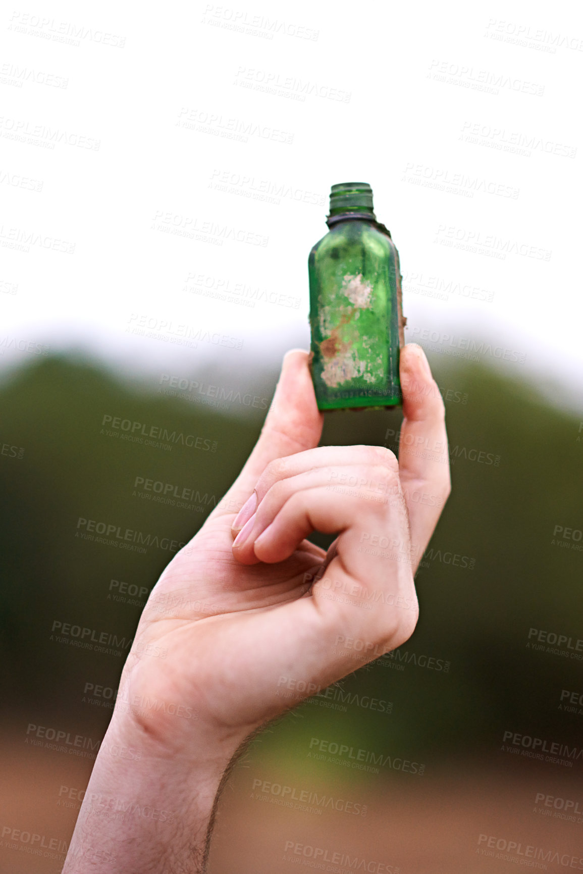 Buy stock photo Person, hand and bottle in nature for recycle, social responsibility and environment care. Man, volunteer and outdoor with glass vial to collect rubbish, cleaning and Earth Day awareness with ecology