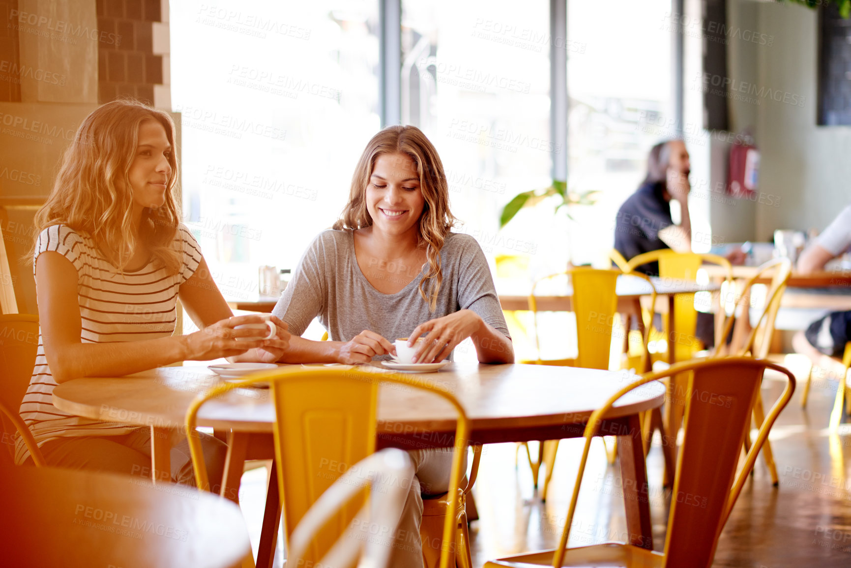 Buy stock photo Sisters, smile and gossip in cafe for social meeting, connection and bonding at lunch date. Cappuccino, brunch and twin women in coffee shop together for morning drinks, chat and restaurant reunion