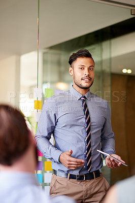 Buy stock photo Man, meeting and presentation in office, business workshop and speaking to coworkers in boardroom. Briefing, team training and professional explaining news story in workplace, journalist and talking