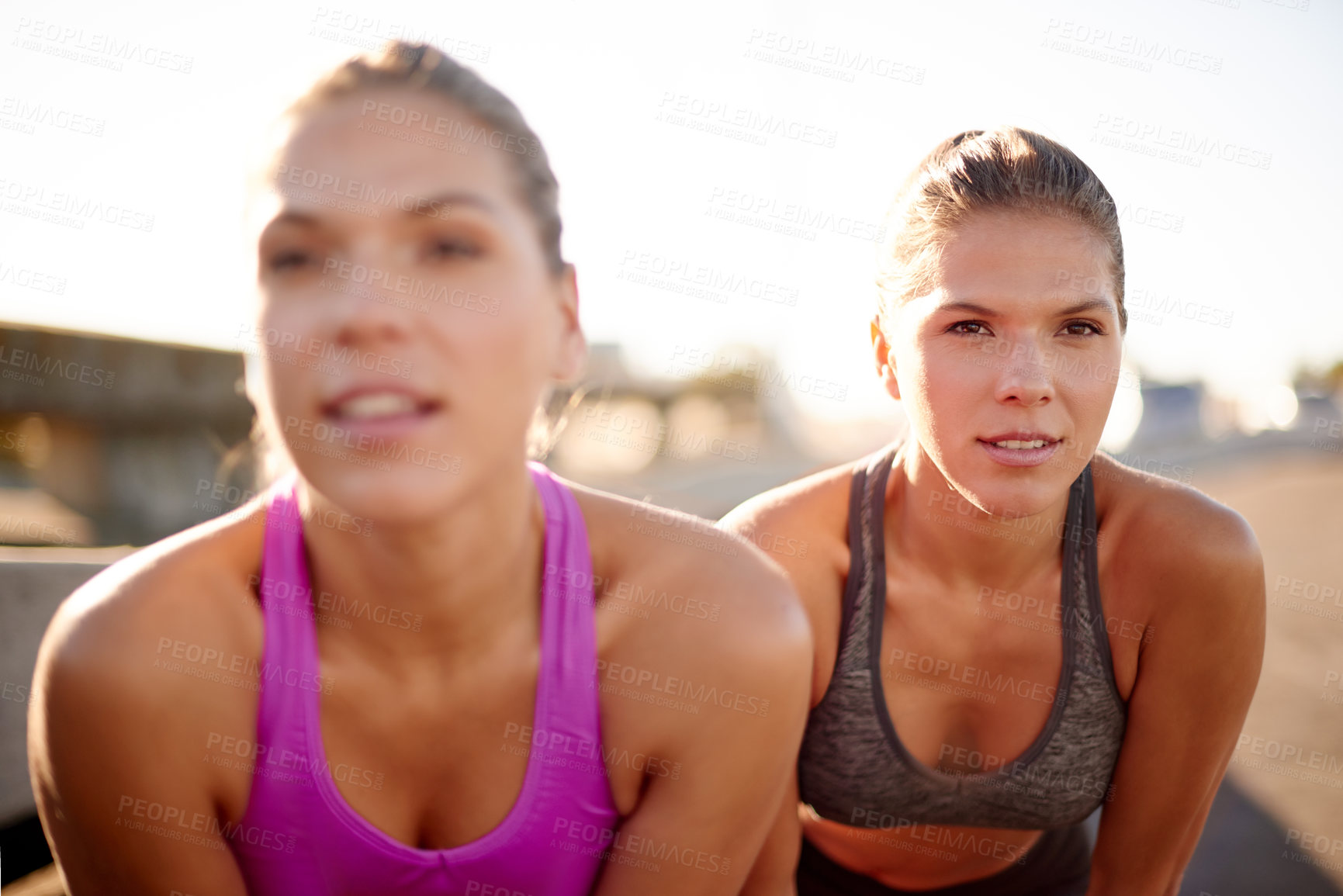 Buy stock photo Fitness, women and resting for exercise outdoor with endurance challenge, cardio workout and tired. Twin sisters, teamwork and relax from running training, marathon competition and recovery on bridge