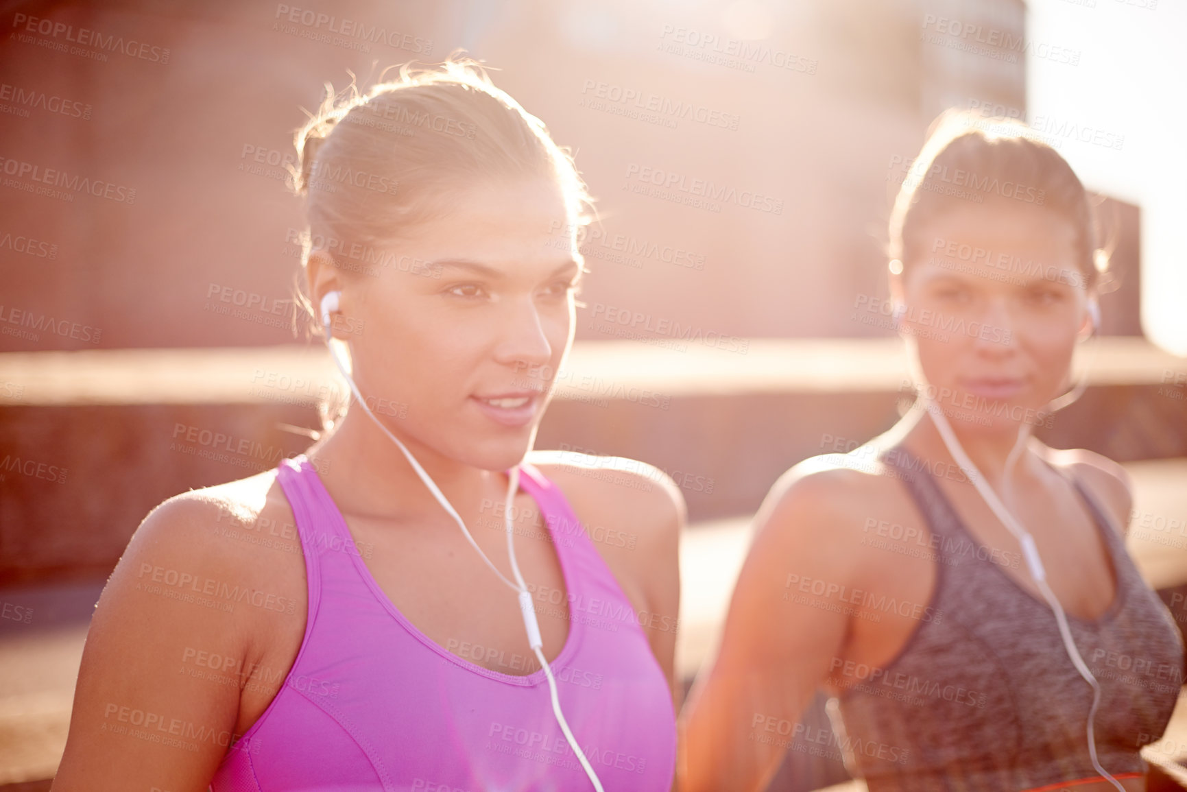 Buy stock photo Fitness, music and women with earphones, exercise and training with sportswear in morning and sisters. Twins, athlete and people with routine for wellness, together and healthy with workout in city