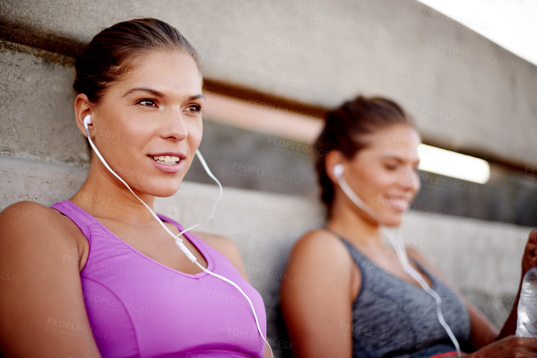 Buy stock photo Music, relax and runner with family in city for fitness podcast, workout and exercise playlist. Health, wellness and earphones with women training outdoors for sports athlete, twin sister or marathon