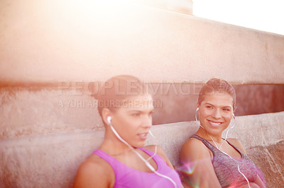 Buy stock photo Fitness, happy and women with resting outdoor for cardio break, listening to music and tired of challenge. Twin sister, people and space on bridge with earphones for workout radio, podcast and flare